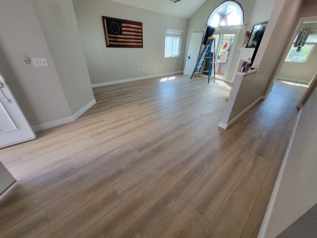 living room after vinyl plank and new baseboards